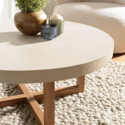 Macabane Table basse ronde en béton beige pieds croisés en teck DAK